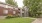 Apartment building with red siding surrounded by trees